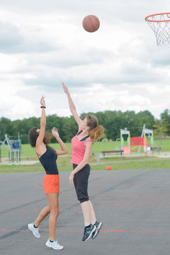 Players Practising Netball In Playground