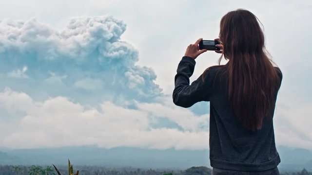 Girl near field with volcano view
