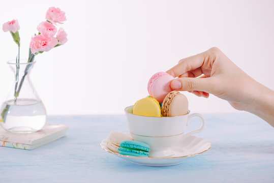 Sweet dessert. Colorful macarons on table in morning.