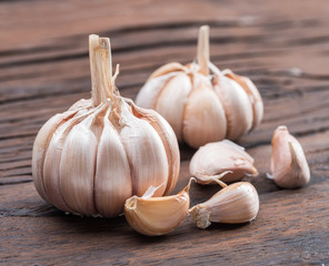 Garlic bulb and garlic cloves on the wooden table.