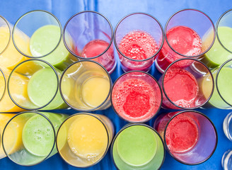 Colorful glasses of fruit juice. Top view.
