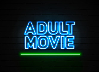 Adult Movie neon sign mounted on brick wall.