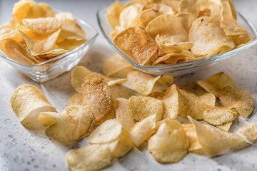 potato chips on a plate on a white background