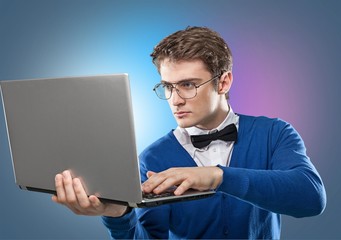 Male hands holding and using laptop