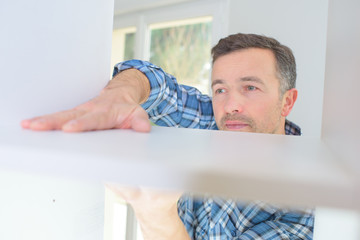 Fototapeta premium man assembling furniture
