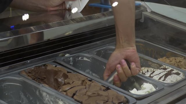 Hand scooping ice cream