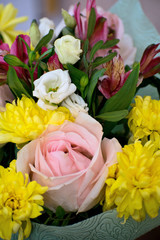 Beautiful bouquet with pink roses, yellow chrysanthemums and purple alstroemeria. Tender spring bouquet.