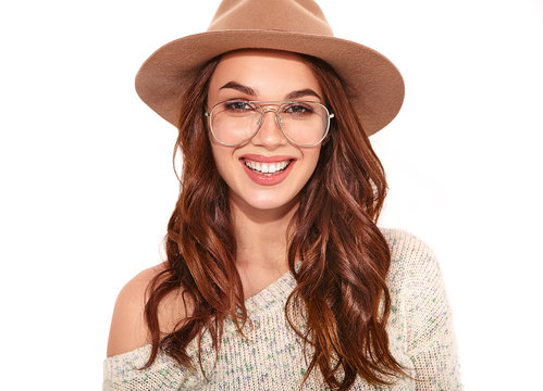 Portrait of young stylish girl model in casual summer clothes in brown hat with natural makeup in glasses isolated on white background. Looking at camera