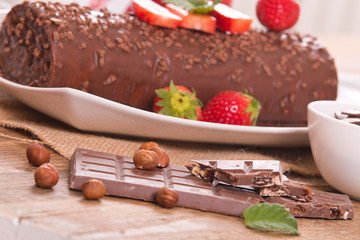 Chocolate roll with strawberries. 