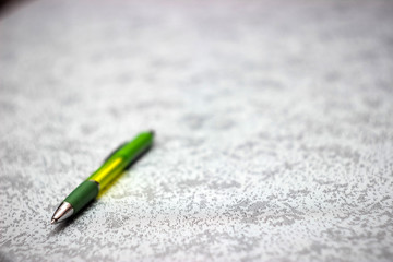 Yellow pen on cloth background.