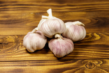 Bulbs of garlic on wooden table
