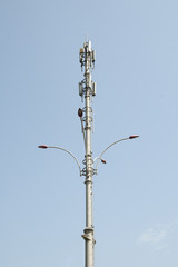 Telecommunications repeater tower against a clear blue sky.