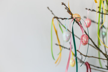 colorful easter eggs hanging on branch. isolated on white background