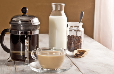 Coffee with milk, french press and milk bottle are together . - 195461446