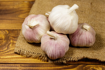 Bulbs of garlic on wooden table