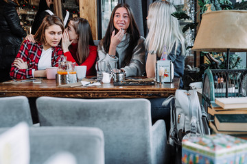 four friends gossiping in a cafe