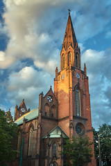 Fototapeta na wymiar Gothic church tower with clock in Poznan.