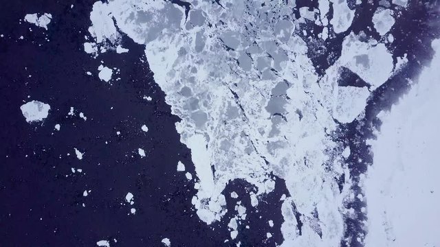 Aerial footage of beautiful winter landscape. Snow covered fjord viewed from air. Dramatic frozen countryside in Iceland.