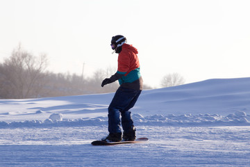 A man on a snowboard in a ski resort