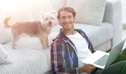 successful guy and his pet in a cozy living room.