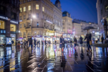 Fototapeta na wymiar people walking on rainy night in the city 