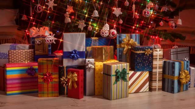 Gifts appearing under the christmas tree with twinkling lights - stop motion animation