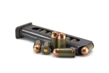 The clip with the cartridges of the Makarov pistol on a white background close up
