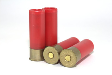 Four old cartridges for shotgun on white background close-up