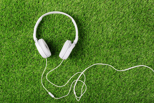 White headphones on a green grass