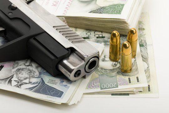 gun and czech banknotes, crime concept