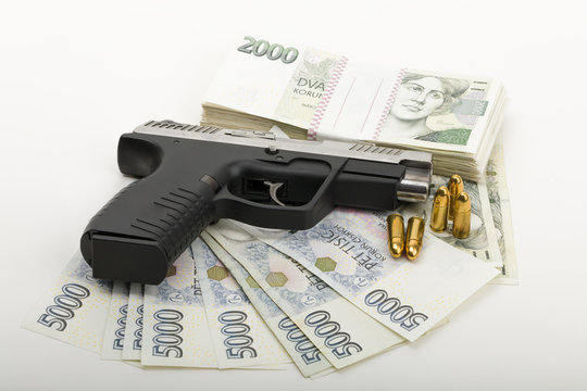 gun and czech banknotes, crime concept