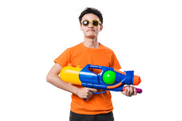 Young man holding water gun on white background.