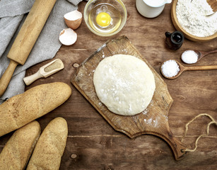 yeast dough made from white wheat on a brown wooden board