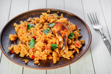 Rice with vegetables and chicken on a wooden table