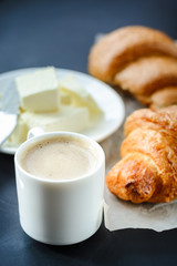 cup of coffee and croissants with butter