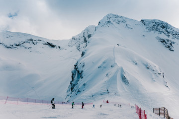 Skiers and snowboarders skiing in the mountains