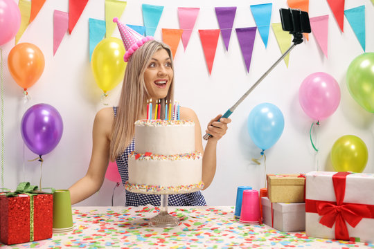 Young woman celebrating her birthday and taking a selfie