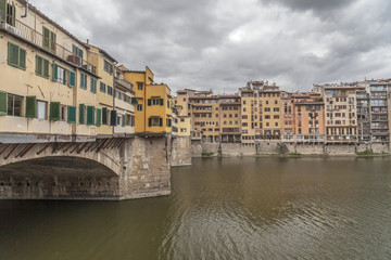 Naklejka na ściany i meble Iconic monument, bridge, Ponte Vecchio, medieval stone construction over Arno river. Tuscany, Italy.