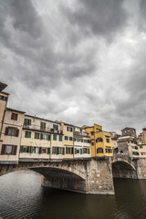 Obraz premium Iconic monument, bridge, Ponte Vecchio, medieval stone construction over Arno river. Tuscany, Italy.