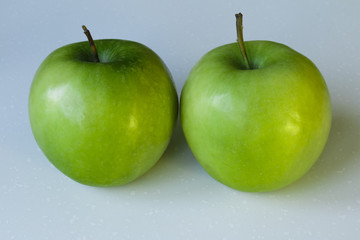 Closeup of Green Apples on White Background.