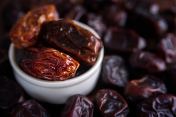 Fresh dates fruit in white ceramic bowl