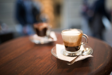 Cappuccino served on a wooden bistro table