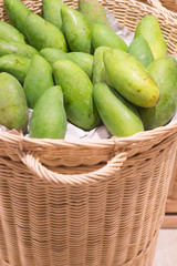 Fresh green raw manggoes display for sale at market