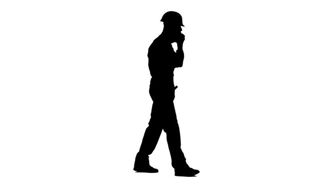 Builder speaks on the phone and screams at his subordinates. White background. Silhouette. Side view