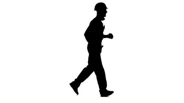 Builder in a helmet run to work with wooden boards in his hands. White background. Silhouette. Side view