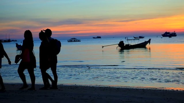 silhouette of tourist walking on  sea beach at koh tao suratthani thailand