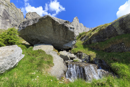 Balancing rock and torrent in Torrone Valley, Valmasino, Valtellina, Lombardy