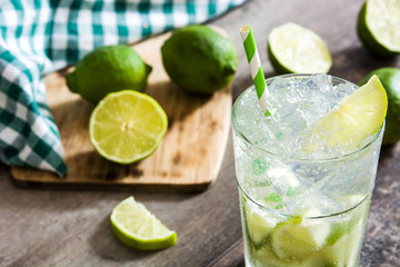 Caipirinha cocktail in glass on wooden table background.