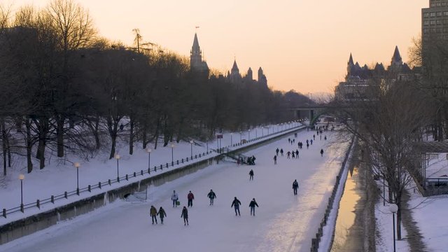 Pan of People Ice Skating on The Rideau Canal in Winter