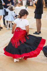 Rear view child dancing wearing typical spanish regional costume. Flamenco. Andalucia. Spain